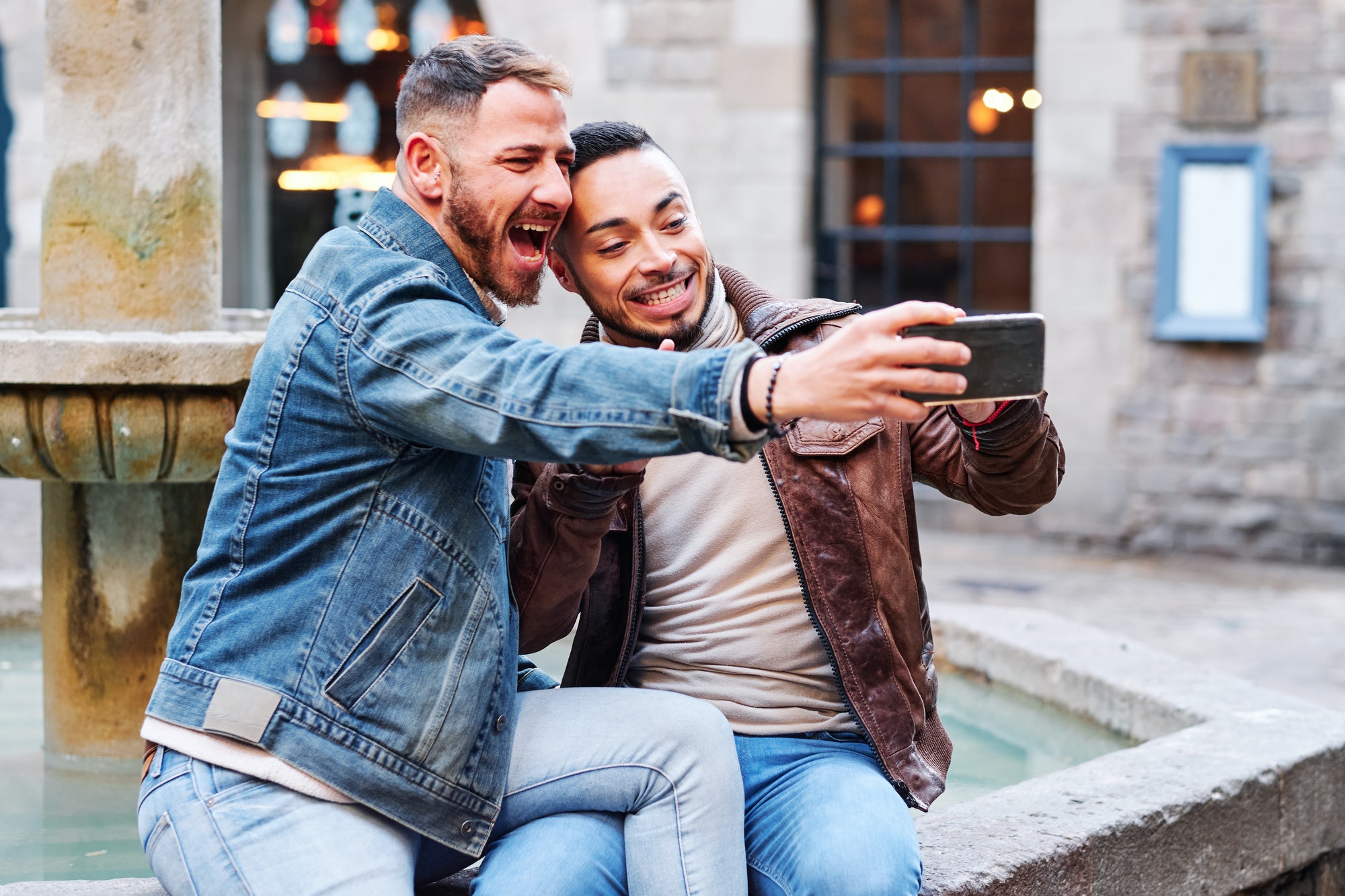 a gay couple at Barcelona making a selfie - gay concept